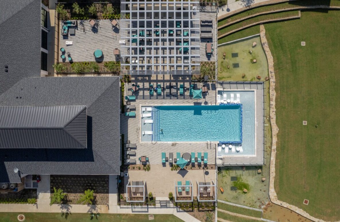 Aerial view of an apartment community pool and courtyard
